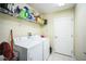 Functional laundry room with a washer, dryer, and storage shelving at 2340 Lawrence Hall St, Ruskin, FL 33570