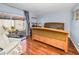 Cozy bedroom with hardwood floors, sliding glass door to patio, and neutral wall color at 2492 Laurelwood Dr # E, Clearwater, FL 33763