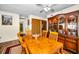 Formal dining room featuring hardwood floors, a wooden table with seating for six, and a china cabinet at 2492 Laurelwood Dr # E, Clearwater, FL 33763