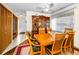 Formal dining room featuring hardwood floors, a wooden table with seating for six, and a china cabinet at 2492 Laurelwood Dr # E, Clearwater, FL 33763