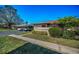 Well-maintained home exterior with manicured lawn and carport at 2492 Laurelwood Dr # E, Clearwater, FL 33763