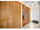 Hallway with wood closet doors, decorative shelving, and a white front door at 2492 Laurelwood Dr # E, Clearwater, FL 33763