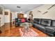 Cozy living room showcasing hardwood floors, comfortable seating, and an adjoining dining space at 2492 Laurelwood Dr # E, Clearwater, FL 33763