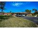 Wide shot of multiple covered parking spots in front of charming one-story homes and green grass at 2492 Laurelwood Dr # E, Clearwater, FL 33763