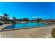 Large community pool with clear blue water, ladder access, and deck chairs for relaxing at 2492 Laurelwood Dr # E, Clearwater, FL 33763