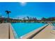 Community pool with clear blue water and lounge chairs at 2492 Laurelwood Dr # E, Clearwater, FL 33763