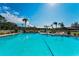 Community pool with clear blue water and sunny sky at 2492 Laurelwood Dr # E, Clearwater, FL 33763