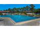 Large community pool featuring clear blue water on a sunny day with houses nearby at 2492 Laurelwood Dr # E, Clearwater, FL 33763