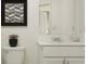 Well-lit bathroom showcases a floating vanity, and contemporary mirror and decorative potted plant at 2652 Sunray Venus Way, Ruskin, FL 33570