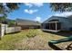 View of the backyard featuring a play set, shed, and screened patio area at 3902 Ixora Ct, Riverview, FL 33578