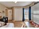 Bright bedroom featuring wood floors, natural light, and closet with 'Nathan' nameplate at 3902 Ixora Ct, Riverview, FL 33578