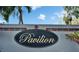 Community sign for The Pavilion is set against a sunny blue sky with palm trees in the background at 3902 Ixora Ct, Riverview, FL 33578