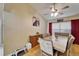 Dining room featuring wood floors, a ceiling fan, and a charming decorative sign at 3902 Ixora Ct, Riverview, FL 33578