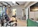 Home gym with exercise equipment and travertine floors, open to bathroom at 3902 Ixora Ct, Riverview, FL 33578