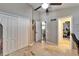 Hallway with travertine floors leading to a room featuring exercise equipment at 3902 Ixora Ct, Riverview, FL 33578