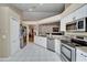 Spacious kitchen featuring stainless steel appliances, granite countertops, and white cabinetry at 3902 Ixora Ct, Riverview, FL 33578