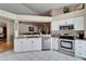 Well-lit kitchen with modern appliances, white cabinets, and a breakfast bar at 3902 Ixora Ct, Riverview, FL 33578