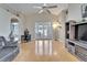 Spacious living room featuring hardwood floors, vaulted ceilings, a fan, and a gray sectional sofa at 3902 Ixora Ct, Riverview, FL 33578