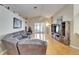 Spacious living room featuring hardwood floors, vaulted ceilings, a fan, and a gray sectional sofa at 3902 Ixora Ct, Riverview, FL 33578