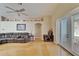 Spacious living room featuring hardwood floors, vaulted ceilings, a fan, and a gray sectional sofa at 3902 Ixora Ct, Riverview, FL 33578