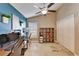 Spacious home office with vaulted ceilings, a blue accent wall, and travertine floors at 3902 Ixora Ct, Riverview, FL 33578