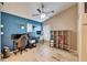 Home office with blue accent wall, two work stations, and travertine floors at 3902 Ixora Ct, Riverview, FL 33578