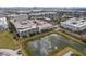 Aerial picture of a building situated next to a serene pond, with an orange pinpoint marker at 4221 W Spruce St # 1414, Tampa, FL 33607