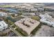 Aerial view of the residential complex surrounded by parking lots, city buildings and pond at 4221 W Spruce St # 1414, Tampa, FL 33607