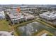 Overhead shot of a building adjacent to a pond, highlighting the property's features at 4221 W Spruce St # 1414, Tampa, FL 33607