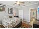 Cozy bedroom with a TV, ceiling fan, and ensuite bathroom entrance at 4221 W Spruce St # 1414, Tampa, FL 33607