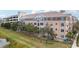 Exterior building view with mature trees and green space at 4221 W Spruce St # 1414, Tampa, FL 33607