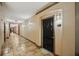 Neutral hallway with tile floors leading to apartment doors in a multi-Gathering building at 4221 W Spruce St # 1414, Tampa, FL 33607