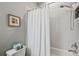 Clean bathroom featuring a shower with white tile and a white shower curtain at 4303 Ortona Ln, Wesley Chapel, FL 33543