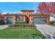 Charming two-story home features a well-manicured lawn, colorful bushes and a two-car garage at 4303 Ortona Ln, Wesley Chapel, FL 33543