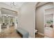 Hallway with tile flooring, leading to a view of the living room with comfortable seating at 4303 Ortona Ln, Wesley Chapel, FL 33543