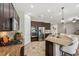 Modern kitchen featuring dark wood cabinets, granite countertops, and stainless steel appliances at 4303 Ortona Ln, Wesley Chapel, FL 33543