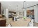 Open-concept kitchen and dining area with modern appliances, granite countertops and view to the living room at 4303 Ortona Ln, Wesley Chapel, FL 33543