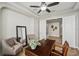 Well-lit office with a ceiling fan, neutral colors, and a brick accent wall at 4303 Ortona Ln, Wesley Chapel, FL 33543