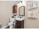 Neat half-bath featuring a modern vanity, and decoratively displayed towels and toiletries at 4310 W San Luis St, Tampa, FL 33629