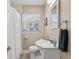 Bright bathroom featuring white fixtures, tile flooring, and a tub-shower combination at 4310 W San Luis St, Tampa, FL 33629