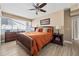 Cozy bedroom features a wooden bed frame, dresser, and ample natural light from the large window at 4310 W San Luis St, Tampa, FL 33629