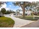 House exterior featuring a long driveway, fenced front yard, and mature trees at 4310 W San Luis St, Tampa, FL 33629