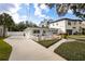 Attractive single-story home with a quaint white picket fence, patio seating, and a spacious driveway at 4310 W San Luis St, Tampa, FL 33629