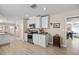 Modern kitchen with stainless steel appliances, white cabinets, and an adjacent breakfast nook with bar stools at 4310 W San Luis St, Tampa, FL 33629