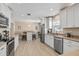 Bright, updated kitchen featuring white cabinetry, stainless steel appliances, and a breakfast bar with seating at 4310 W San Luis St, Tampa, FL 33629