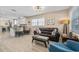 Open-concept living area with modern lighting, tile floors, and a view of the kitchen and breakfast bar at 4310 W San Luis St, Tampa, FL 33629