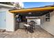 Outdoor kitchen with a bar, grill, and shaded seating area at 4310 W San Luis St, Tampa, FL 33629