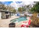 Backyard pool area with a patio, lounge chairs, and manicured landscaping at 4310 W San Luis St, Tampa, FL 33629