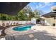 Inviting backyard pool area with a covered bar, manicured landscaping, and brick paver patio at 4310 W San Luis St, Tampa, FL 33629