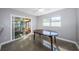 Bright dining area with a vintage wooden table and a sliding door that leads to a screened lanai at 4807 Wynwood Dr, Tampa, FL 33615